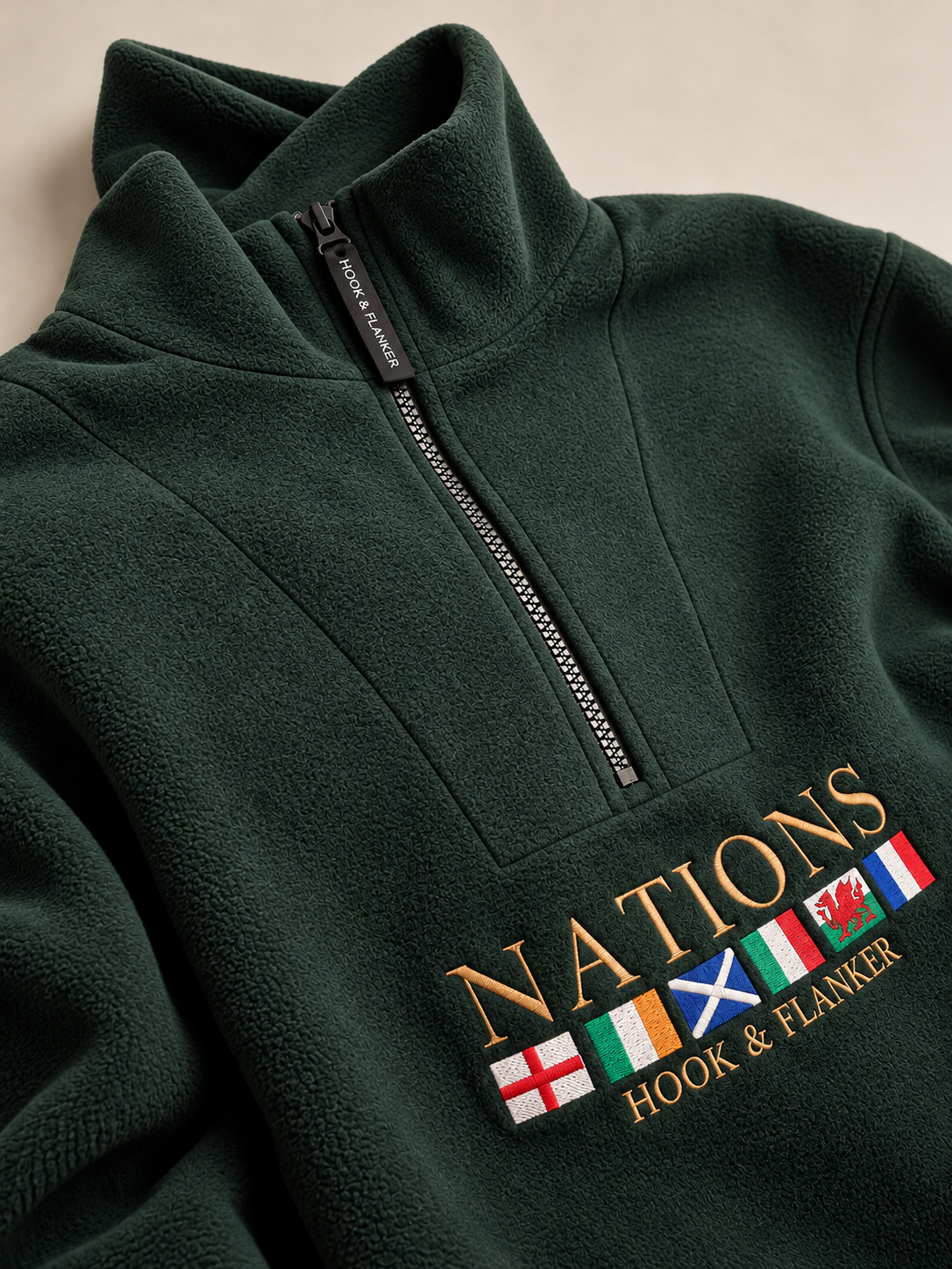 The Nations Fleece in Forest Green, embroidered crest detail