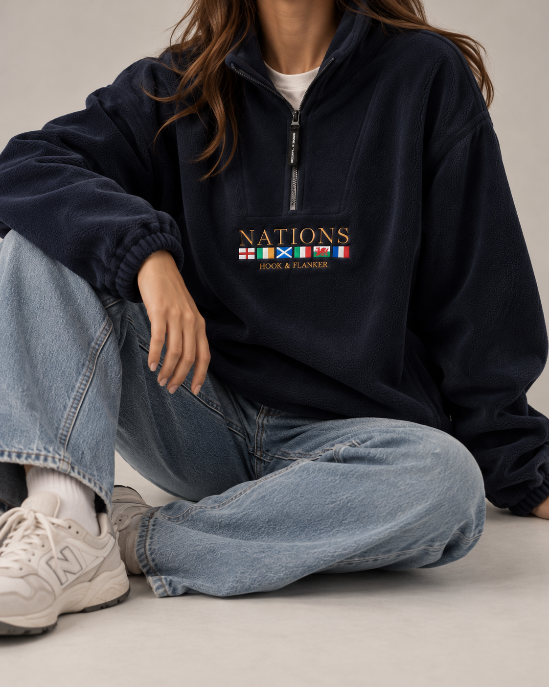 The Nations Fleece in French Navy, worn seated with light denim
